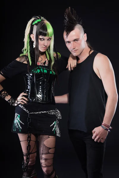Couple of cyber punk girl with green blond hair and punk man with mohawk haircut. Expressive faces. Isolated on black background. Studio shot. — Stock Photo, Image