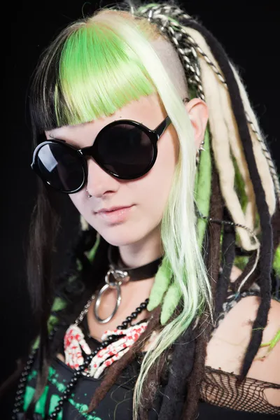 Cyber punk meisje met groene blond haar en rode ogen geïsoleerd op zwarte achtergrond. dragen van een zwarte zonnebril. expressief gezicht. studio opname. — Stockfoto