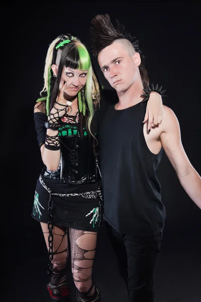Couple of cyber punk girl with green blond hair and punk man with mohawk haircut. Expressive faces. Isolated on black background. Studio shot. — Stock Photo, Image