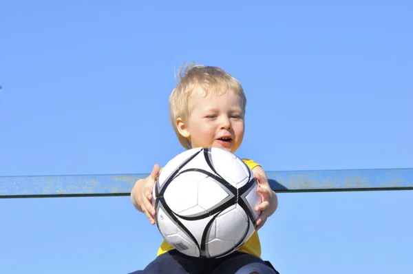 Young boy or kid plays soccer or football sports for exercise an — Stock Photo, Image
