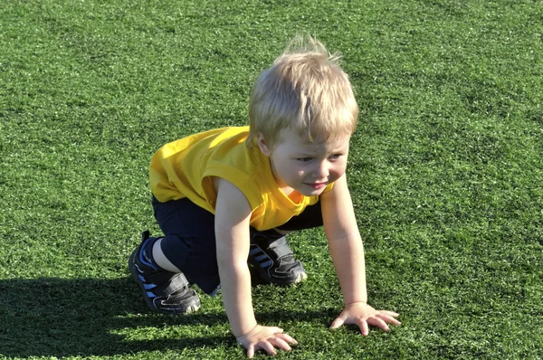 Young boy or kid plays soccer or football sports for exercise an — Stock Photo, Image