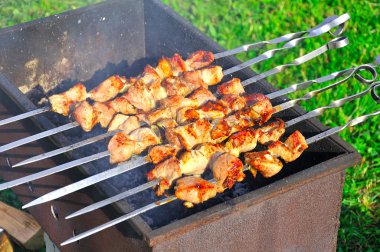 Tasty grill kebab on a charcoal clipart