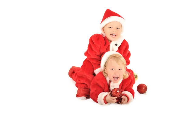Двое детишек в костюмах Санта Клауса, изолированных на белом — стоковое фото