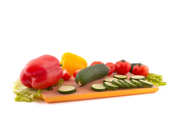 stock image Fresh vegetables on board on white background