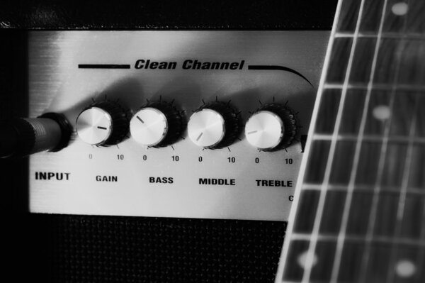 Amplifier in black and white, some strings of electric guitar