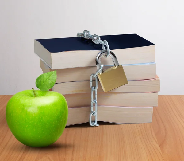Пачка книг и зеленое яблоко — стоковое фото