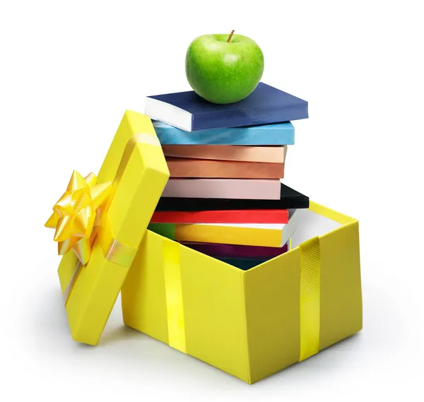 Open yellow gift box, stack of books — Stock Photo, Image