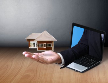 Giving a mini house from laptop clipart