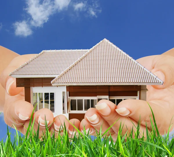 House in human hands — Stock Photo, Image