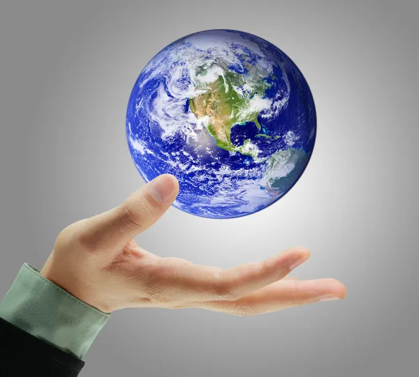 Un globe dans sa main Images De Stock Libres De Droits