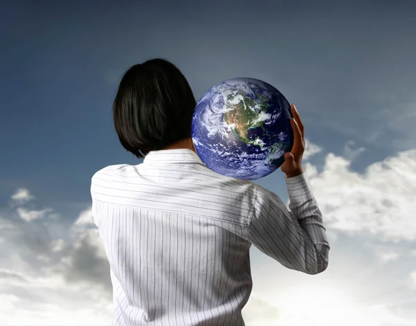 Holding a glowing earth globe in his hands Stock Picture