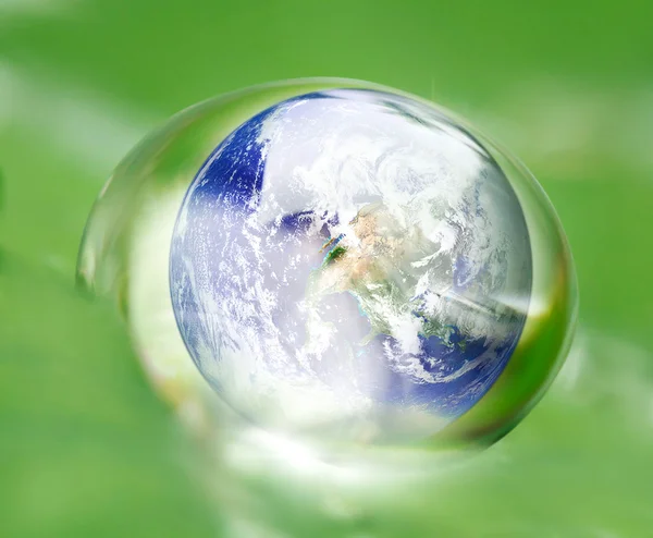 Earth in waterdrop reflection on green leaf — Stock Photo, Image