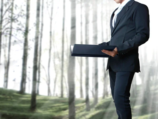 Young business man standing with a file — Stock Photo, Image