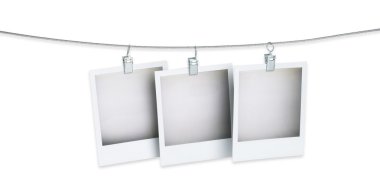 Three blank polaroid pictures hanging on a wire isolated on whit clipart