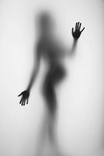 Zwangere vrouw silhouet achter een gordijn — Stockfoto