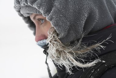 Girl looks away at cold winter day clipart