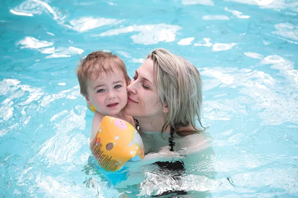 Fiatal anya és a gyermek kék vizű medence — Stock Fotó