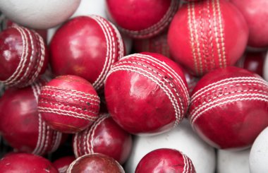 Old, red cricket balls clipart