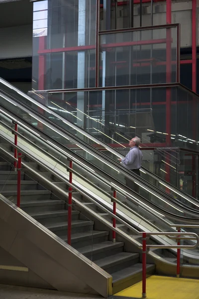 Man on an escalator — Stock Photo, Image