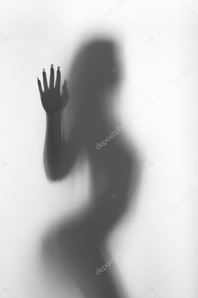 Sexy woman stands behind a curtain, silhouette