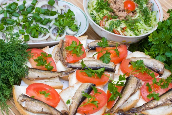 Sandwiches with sprats on a plate — Stock Photo, Image