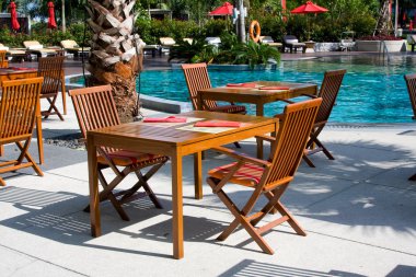 Terrace of a restaurant at the beautiful pool clipart