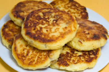 Sweet cheese pancakes on a plate clipart