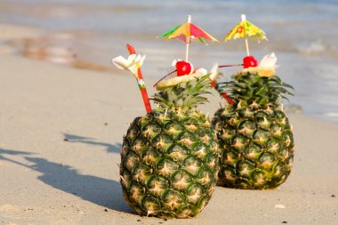 Two tropical cocktails on the beach clipart