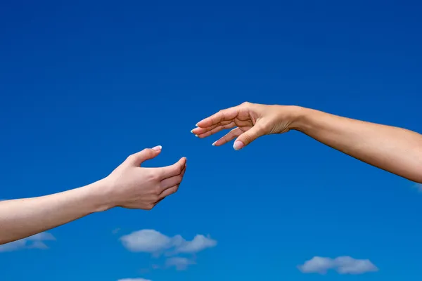 Hand reaching out from the sky — Stock Photo, Image