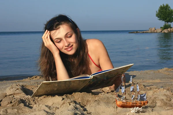 stock image Girl with a book on the sea