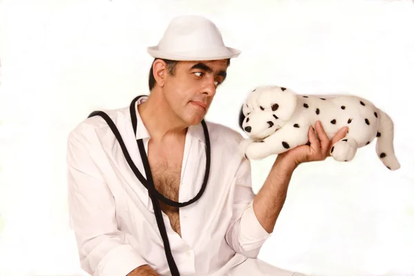 Man in a white hat with toy dogs Dalmatians — Stock Photo, Image