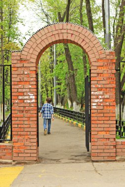 The red brick gate and a going out boy clipart