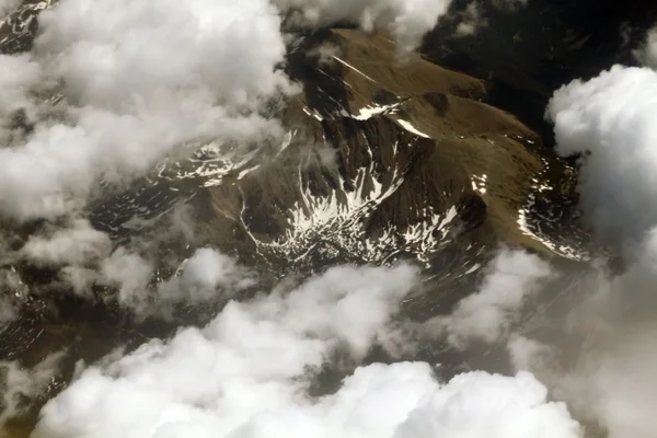 Aerial view on mountains from an airplane window — Stock Photo, Image