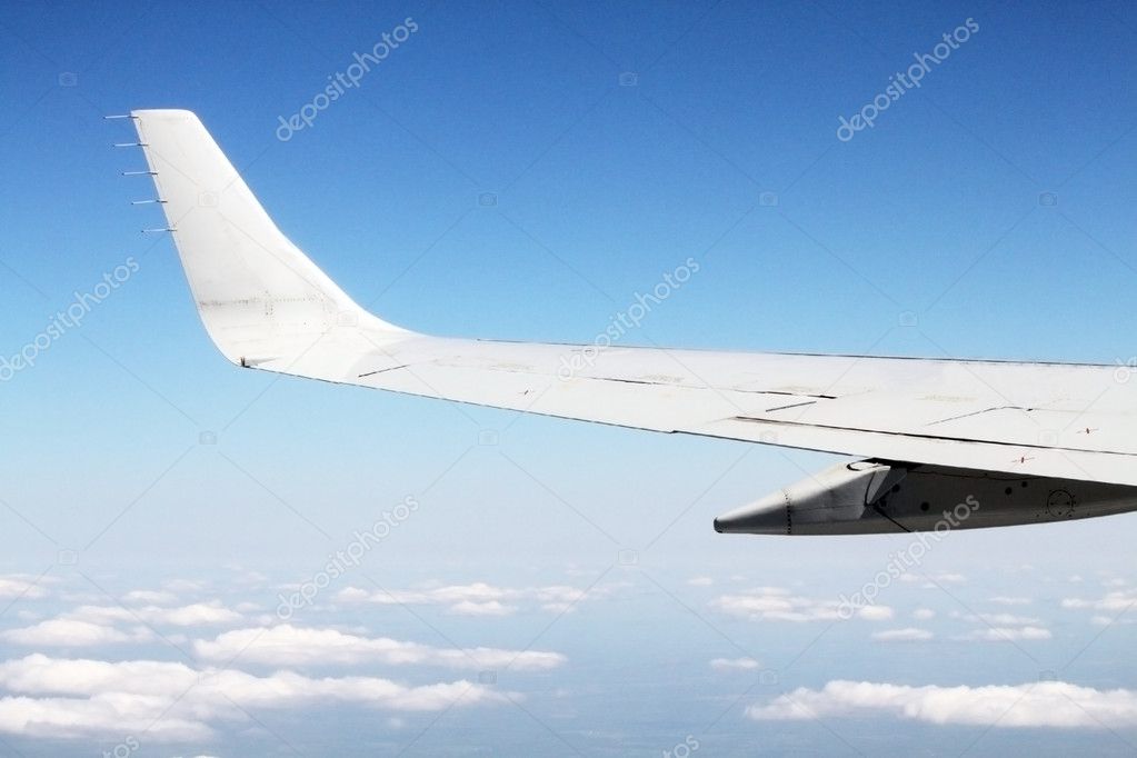 Aerial view of jet plane wing and clouds