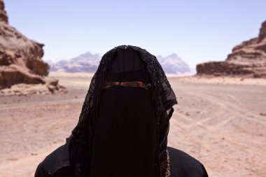 Portrait of Bedouin woman with burka in desert clipart