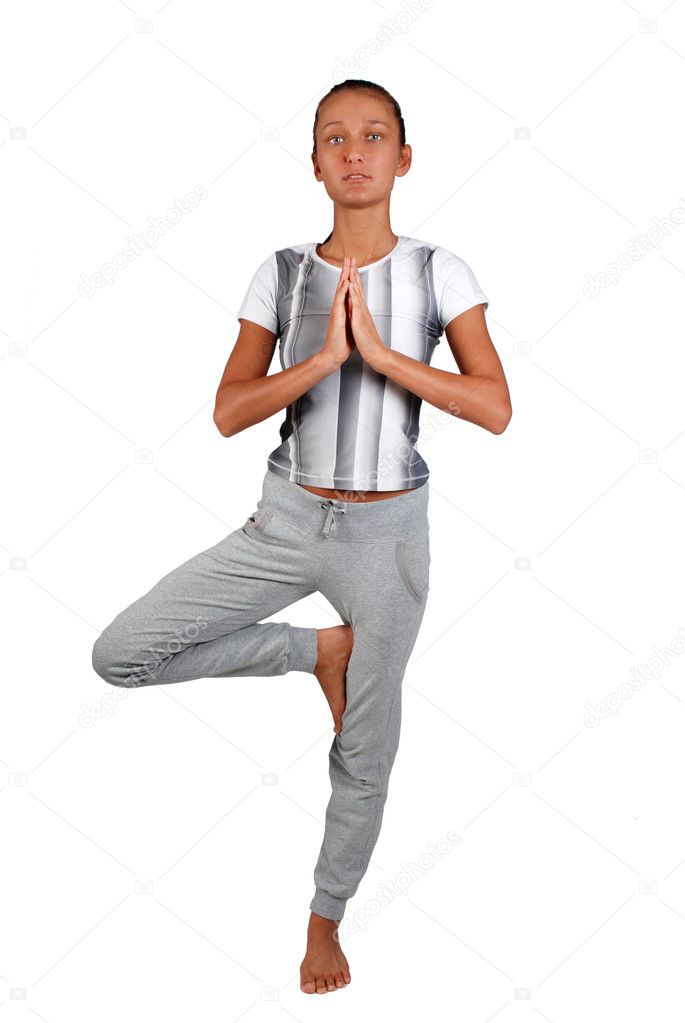 Portrait of beautiful young woman doing yoga exercise - tree pos