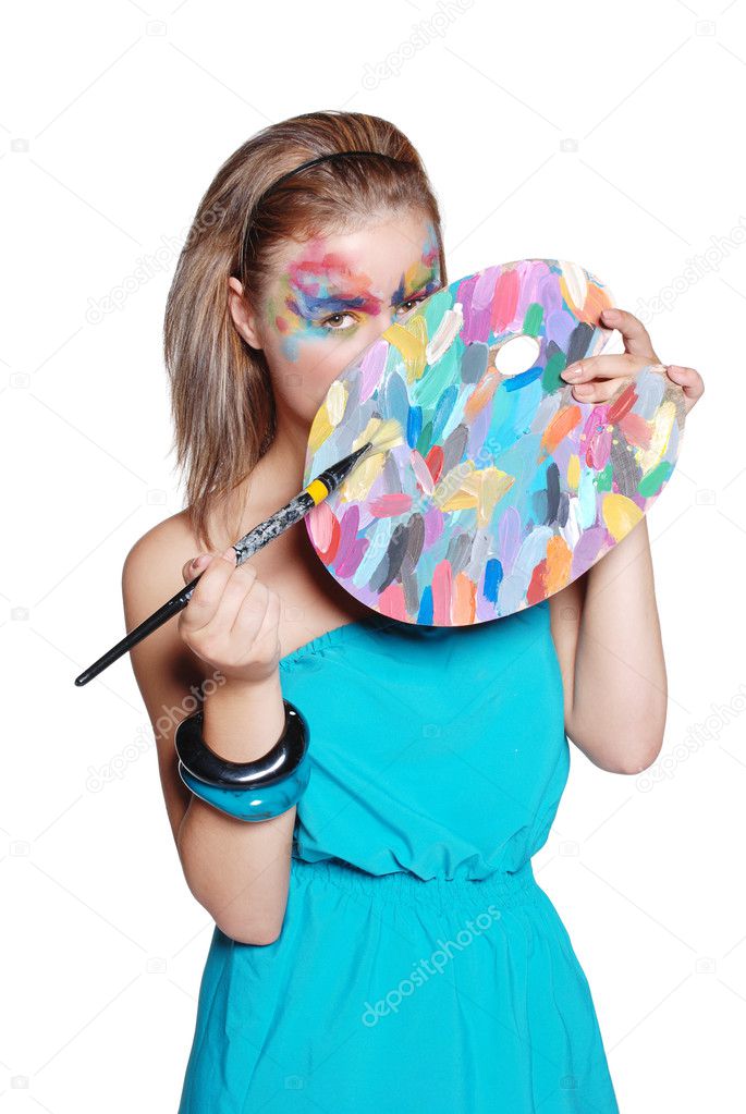 Cute happy girl with colored palette and brushes
