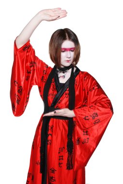 Beautiful young geisha girl in kimono with sword