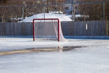 Ice hockey net on melting ice clipart