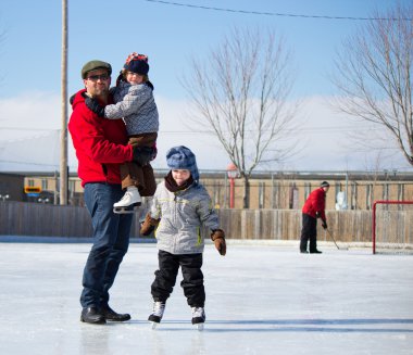 Happy family at the skating rink clipart