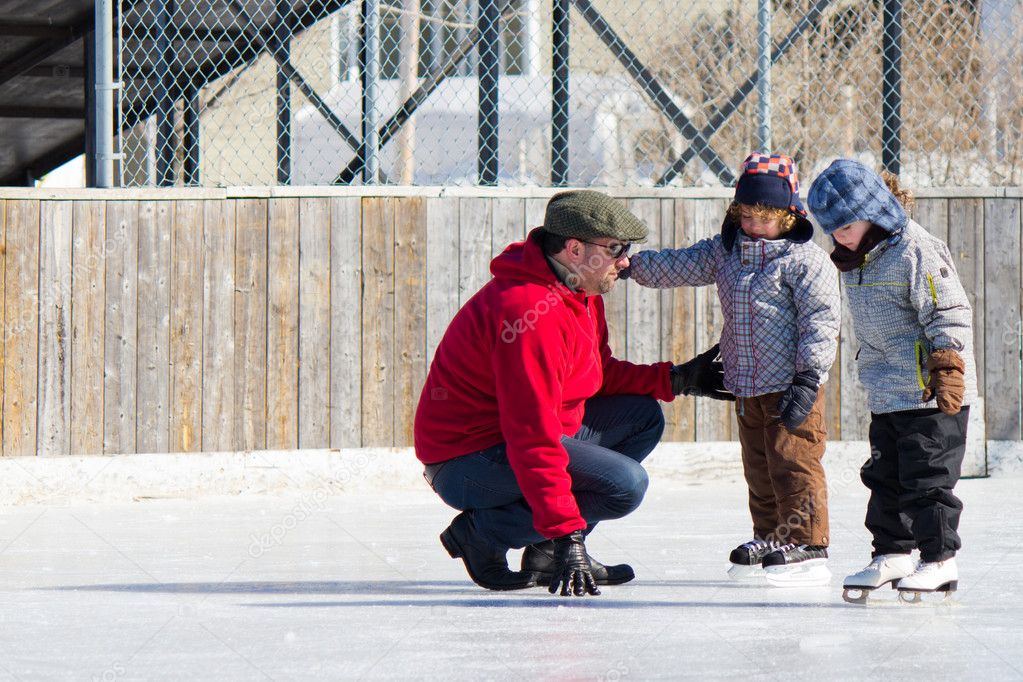 Family having fun at the skating rink