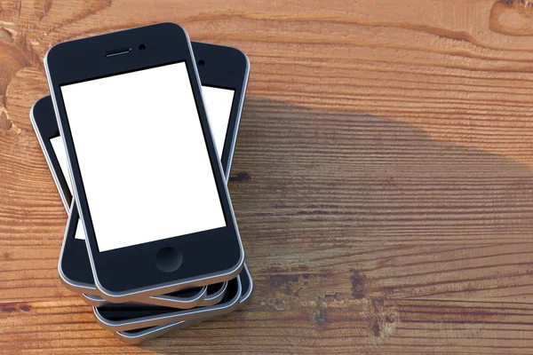 Dokunmatik ekran teknolojisi ile akıllı telefonlar bir ahşap yüzeye (sol kompozisyon sürüm ayarla) — Stok fotoğraf