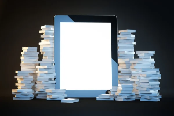 Touch screen pad on a black background among the many paper books — Stock Photo, Image