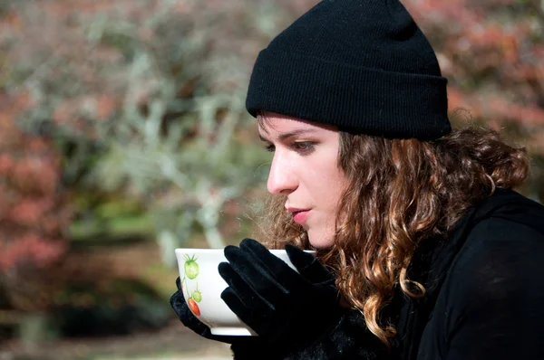 stock image Woman drinking a hot drink