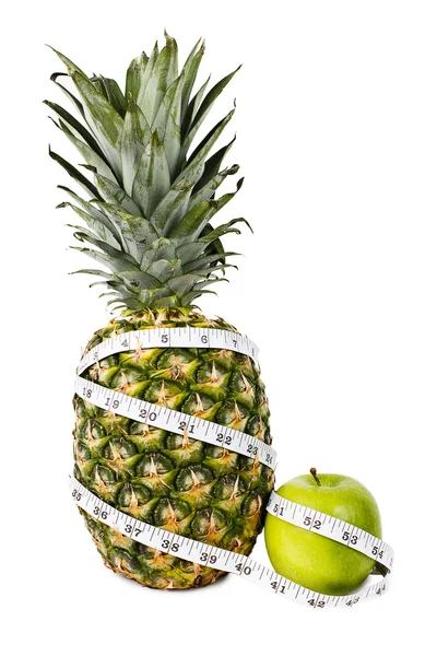 Pineapple and green apple in measuring tape — Stock Photo, Image