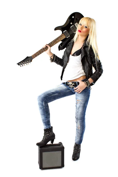 Sexy woman in blue jeans posing with black electric guitar — Stock Photo, Image