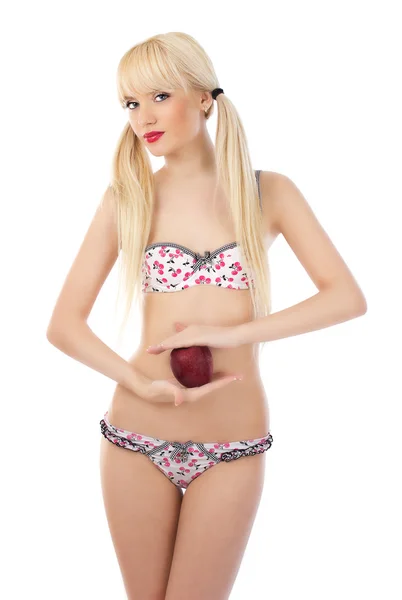 Bella donna bionda in lingerie con mela rossa in mano — Foto Stock
