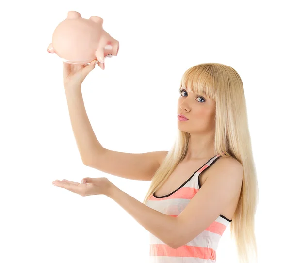 Pretty woman holding piggybank upside down — Stock Photo, Image