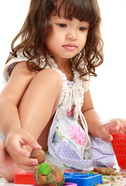 Lille pige med hendes ler - Stock-foto