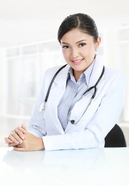 Médico médico mujer sentado en su escritorio — Foto de Stock
